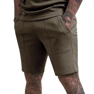 Detailed back view of men's olive green casual athletic shorts featuring stitched front seams