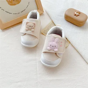 Top view of cute cartoon bear and bunny baby walking shoes with soft soles