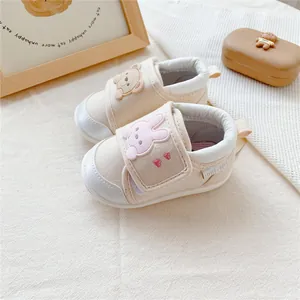 Close-up of cute cartoon bear and bunny baby walking shoes with soft rubber soles
