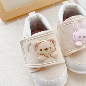 Close-up detail of baby soft sole walking shoes featuring cute 3D cartoon bear and rabbit patches