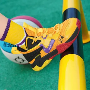 Close-up side view of breathable yellow and purple basketball shoes for youth on a court.