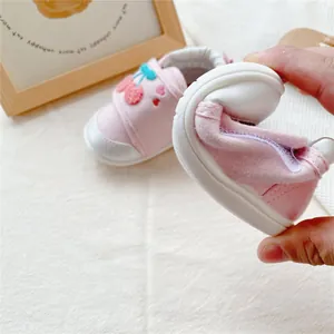Flexible baby walking shoes with soft soles and cute cartoon cherry embroidery.