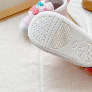 Detailed view of non-slip sole on pink cherry baby walking shoes with size 13.0 mark