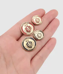 Macro detail of enamel lion crest buttons with gold-tone finish and traditional design