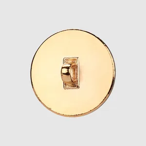 Back view of a round gold metal shank button for elegant clothing and sewing projects.