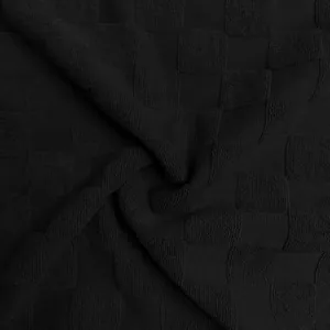 Détail macro du tissu en maille jacquard à damiers noir lourd pour t-shirt à manches longues