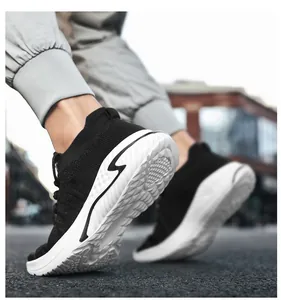 Close-up of lightweight black flyknit walking sneakers with durable textured white sole
