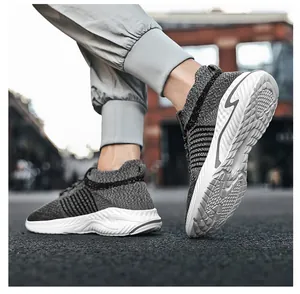 Close-up of grey fly-knit breathable sneakers with durable anti-slip white sole