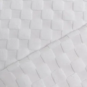 Gros plan détaillé sur la texture d'un tissu en maille jacquard blanc lourd à damier chic