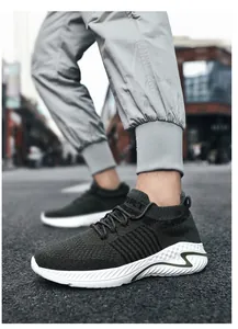 Detail view of breathable dark green flyknit sneakers on street pavement