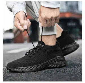 Close-up of breathable black flyknit sports shoes being tied for a secure fit