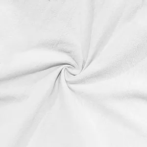 Close-up of white cotton linen fabric showing soft texture and natural fiber weave
