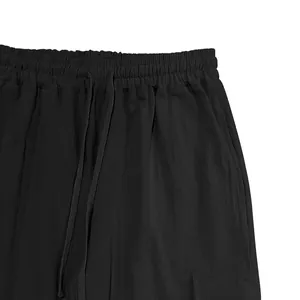 Close-up of elastic drawstring waistband on men's black linen cargo pants