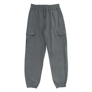 Detailed view of gray cotton linen cargo pants featuring an elastic drawstring waistband