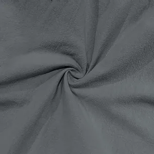 Detailed close-up shot of dark grey cotton linen fabric with natural fiber textures
