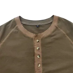 Close-up detail of a brown heavy cotton Henley shirt showing collar and buttons.