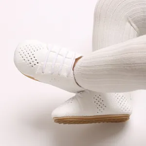 Close-up detail showing the breathable hollow-out texture of white baby princess flat shoes