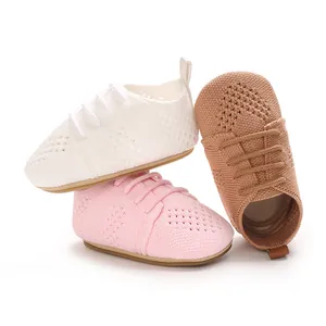 Detailed view of hollow knit baby flat shoes in white, pink, and tan colors.