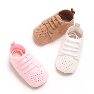 Macro view of breathable hollow knit baby flat shoes in soft pink, khaki and white colors