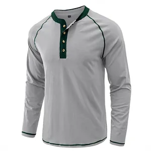 Close-up of a vintage grey cotton Henley shirt featuring contrast green trim and wooden buttons