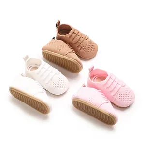 Detail view of retro hollow knit toddler flat shoes in pink, brown, and white colors