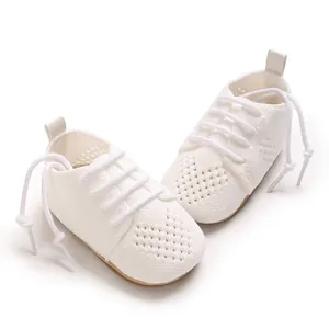 Detailed view of white knitted baby princess shoes with a heart hollow pattern