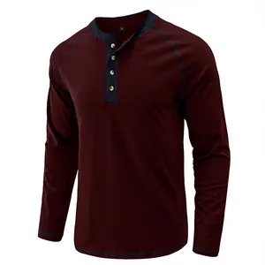 Detail view of men's burgundy long sleeve Henley shirt with navy blue contrast collar detail