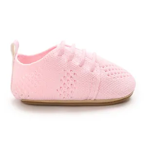 Close-up of pink knitted hollow baby princess shoe with soft breathable texture
