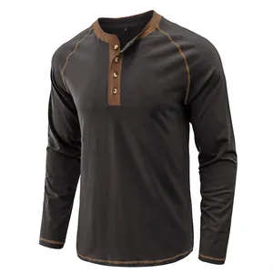 Macro detail of a men's vintage heavy cotton Henley shirt in charcoal grey with tan trim