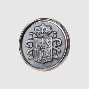 Premium vintage metal button featuring an embossed Spanish crest for high-end apparel