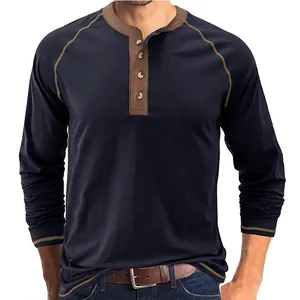 Close-up of a men's navy blue long-sleeve Henley shirt with a retro contrast brown trim.