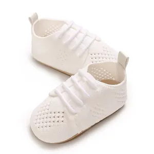 Close-up of white hollow knit baby shoes with breathable mesh and retro princess style