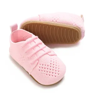 Detailed view of pink hollow knit baby shoes with heart pattern and anti-slip rubber sole
