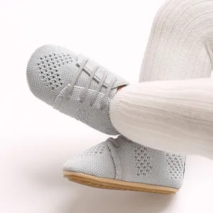 Detail view of breathable knit baby shoes with hollow-out design and rubber soles