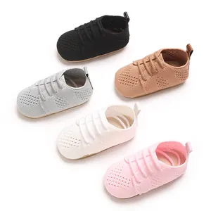 Detailed view of hollow-out knitted infant shoes in multiple soft colors.