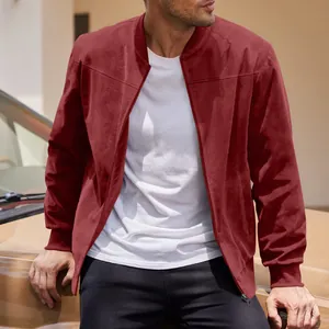 Detail shot of a men's burgundy suede bomber jacket in a stylish outdoor setting.