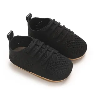 Detailed view of black knitted infant flat shoes with breathable hollow-out design