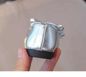 Close-up of silver metallic girl's shoes showing heel stitching and durable rubber sole.