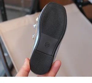 Close-up view of durable non-slip rubber sole for toddler girls' silver loafers size 26