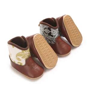 Close-up view of PU printed winter baby boots featuring soft rubber soles and warm fleece lining.