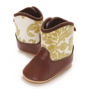Detailed view of baby girl winter boots with gold glitter floral pattern and soft sole.