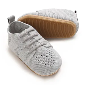 Close-up view of breathable light gray knitted baby shoes with cute heart pattern detail