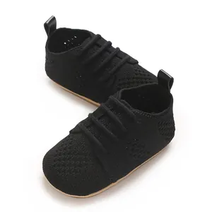 Macro view showing the breathable knitted mesh texture of these black baby walker shoes