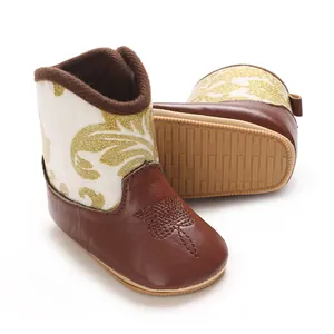 Macro view of baby winter boots showing non-slip soft sole and golden patterns