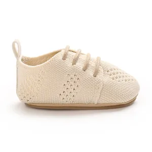 Side view detail of breathable cream-colored knitted mesh baby pre-walker shoe