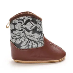 Detailed side view of a brown and silver baby winter boot with soft non-slip sole.
