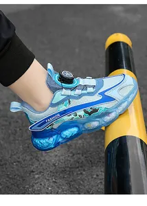 Detail view of boys breathable mesh running shoes with blue bubble sole and dial closure