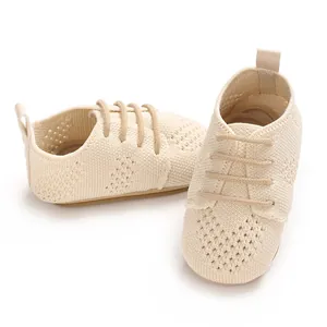 Detailed close-up of breathable beige knitted baby pre-walker shoes for infants.
