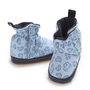 Detail shot of soft light blue cotton baby boots featuring cute cartoon car patterns for newborns