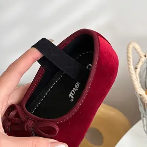 Elegant red velvet girl's Mary Jane princess shoes with a bow detail and elastic strap.